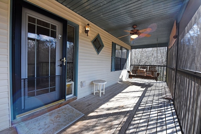 wooden deck with ceiling fan and a porch