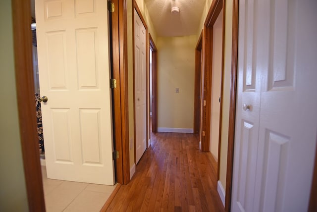 hallway with light hardwood / wood-style flooring