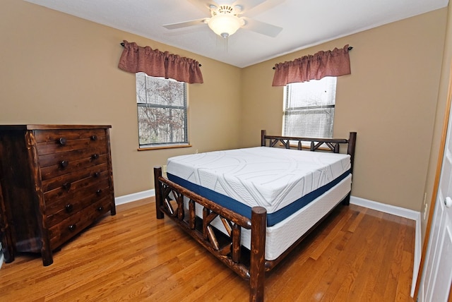 bedroom with light hardwood / wood-style flooring and ceiling fan