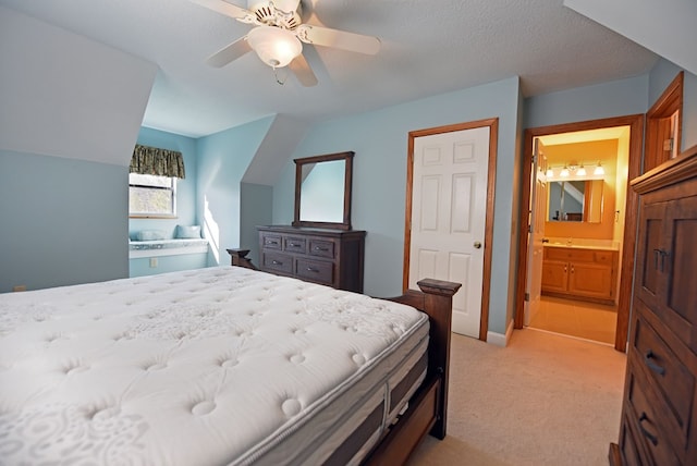 carpeted bedroom with ceiling fan, ensuite bath, and a textured ceiling