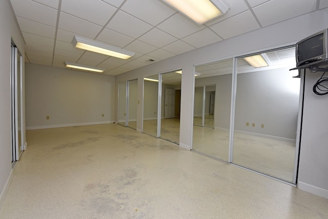 basement featuring a paneled ceiling