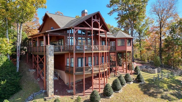 back of house featuring a yard and a deck