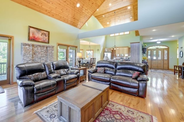 living room featuring an inviting chandelier, wood ceiling, high vaulted ceiling, and light wood-type flooring