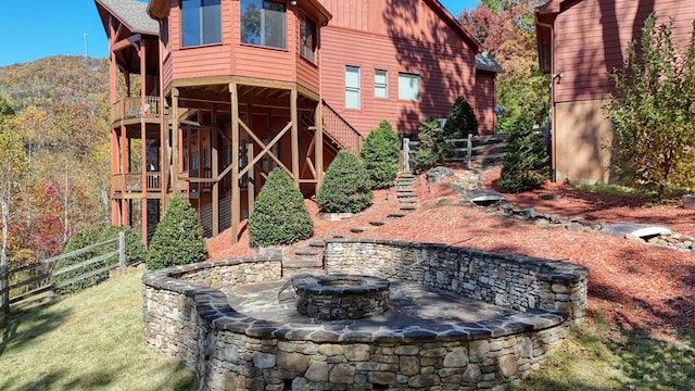 view of yard with an outdoor fire pit and a mountain view