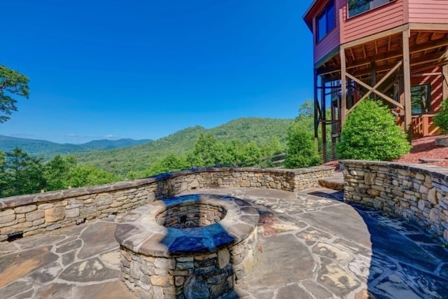 view of patio / terrace featuring a mountain view and a fire pit