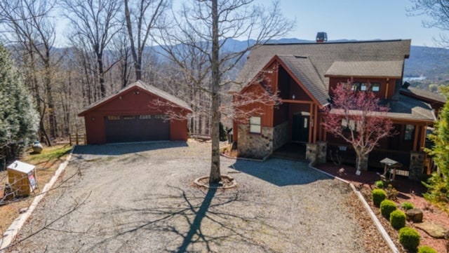 view of front facade featuring an outdoor structure and a garage