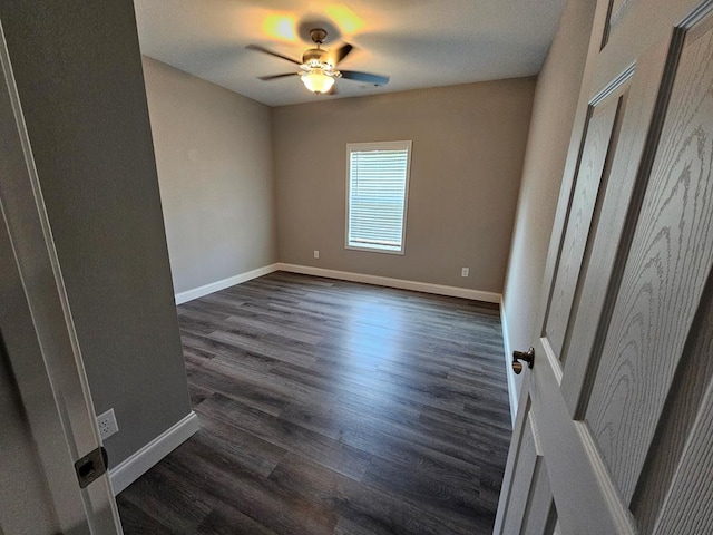 unfurnished room featuring dark hardwood / wood-style flooring and ceiling fan