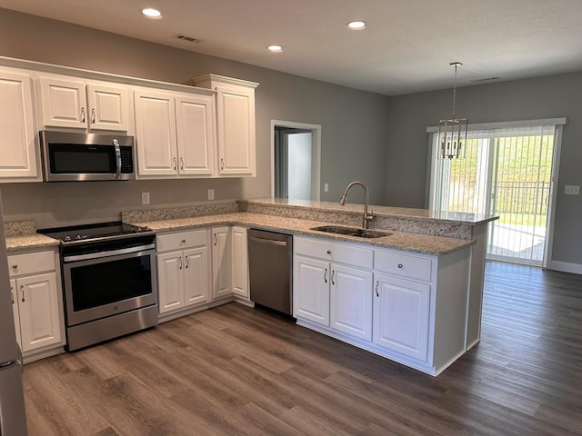 kitchen featuring kitchen peninsula, sink, white cabinetry, and stainless steel appliances