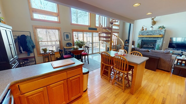 interior space with stairway, recessed lighting, light wood finished floors, and a fireplace