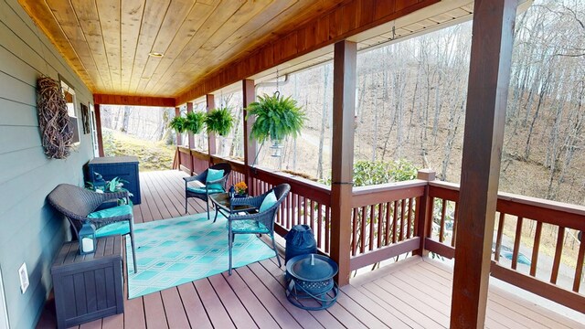 wooden terrace featuring a forest view