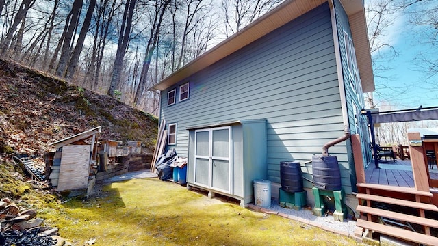 back of house with a wooden deck