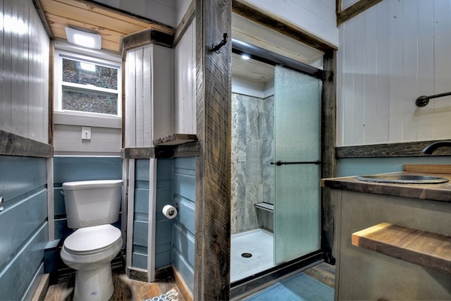 bathroom with walk in shower, sink, hardwood / wood-style floors, wooden walls, and toilet