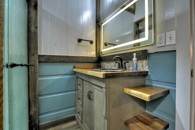 bathroom with vanity and tasteful backsplash