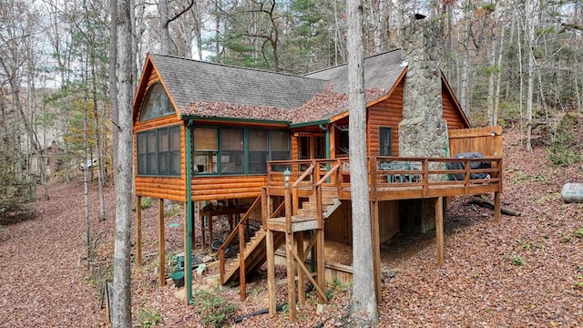 exterior space with a sunroom and a deck