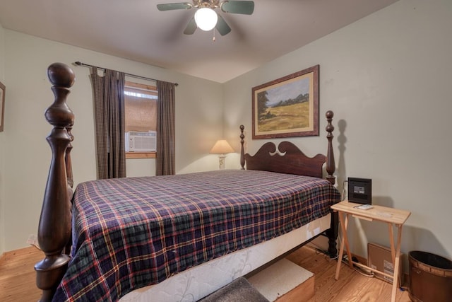 bedroom with light wood-type flooring, cooling unit, and ceiling fan