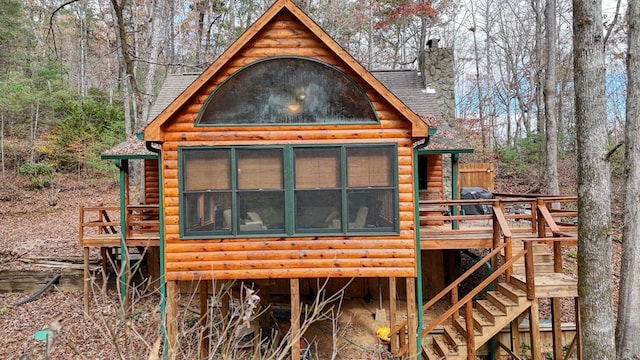 exterior space with a sunroom and a wooden deck