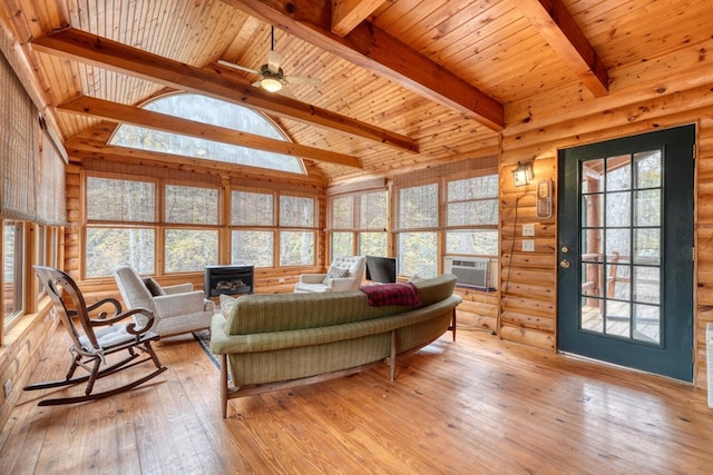 living room featuring light hardwood / wood-style floors, cooling unit, vaulted ceiling with beams, wood ceiling, and a wood stove