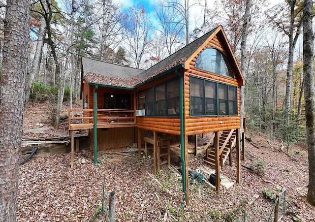 back of property with a sunroom