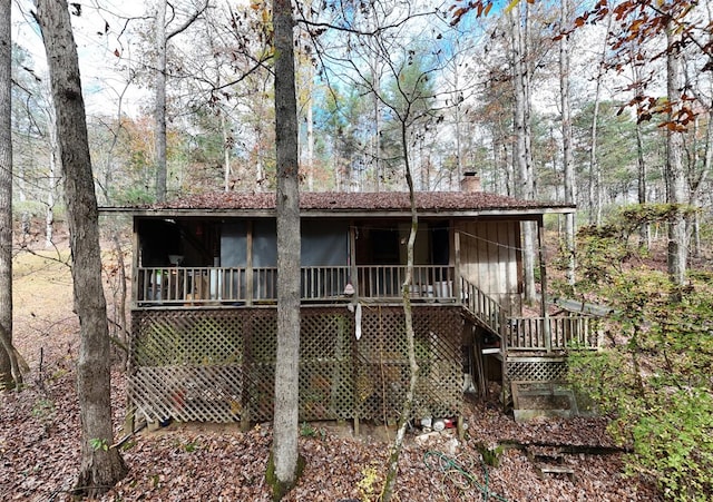 back of house with a wooden deck