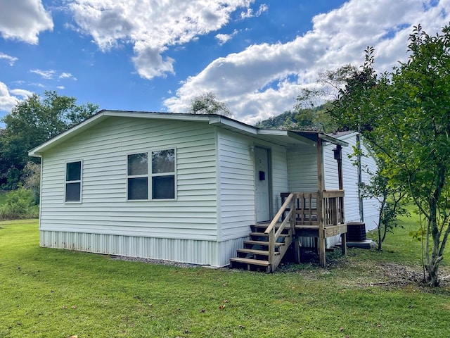 exterior space with a lawn and central AC unit