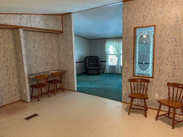 1716 Airport Rd, Marble, NC 28905 - sitting room with tile patterned floors, visible vents, crown molding, wallpapered walls, and vaulted ceiling