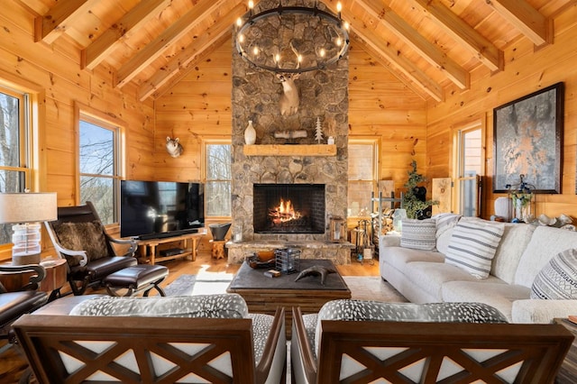 living room featuring an inviting chandelier, hardwood / wood-style flooring, wooden walls, and a healthy amount of sunlight