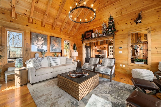 living room with wood ceiling, hardwood / wood-style flooring, beam ceiling, wooden walls, and high vaulted ceiling