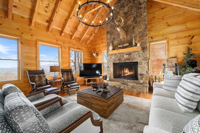 living room featuring wood ceiling, hardwood / wood-style floors, beam ceiling, a chandelier, and wood walls