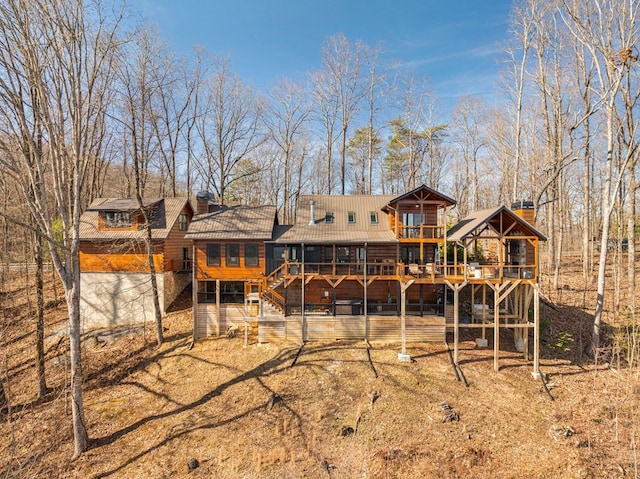 rear view of property featuring a deck