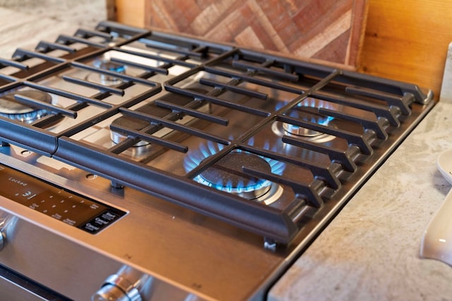 interior details with stainless steel gas range and stovetop