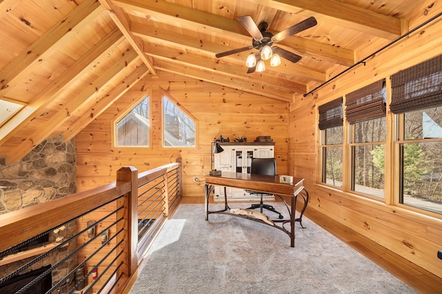 home office featuring vaulted ceiling with beams, plenty of natural light, and wood walls