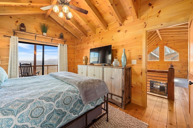 bedroom featuring wooden walls, vaulted ceiling with beams, access to exterior, wood ceiling, and light wood-type flooring