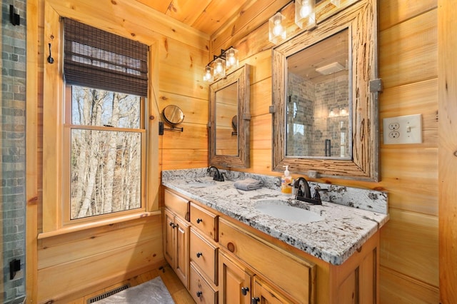 bathroom with vanity and wooden walls