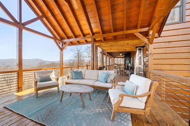 wooden terrace featuring a mountain view and outdoor lounge area