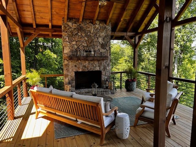 wooden terrace featuring an outdoor living space with a fireplace