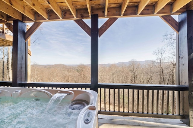 wooden deck with a hot tub