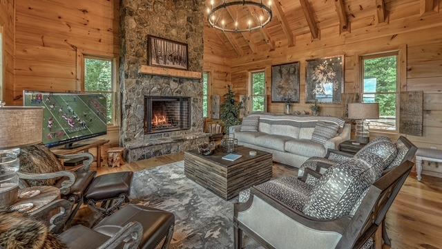 living room with hardwood / wood-style floors, wood ceiling, wooden walls, and a wealth of natural light