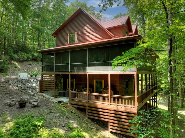 30 Okemah Ct, Ellijay, GA 30540 - view of front of home with a sunroom, a fire pit, stairs, metal roof, and a wooden deck