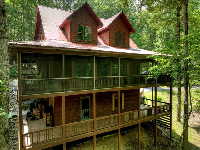 30 Okemah Ct, Ellijay, GA 30540 - view of front of home featuring a sunroom, a wooden deck, and metal roof