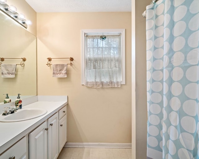 bathroom featuring vanity and a textured ceiling