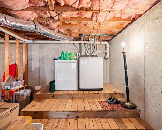 basement with hardwood / wood-style floors and washer and dryer