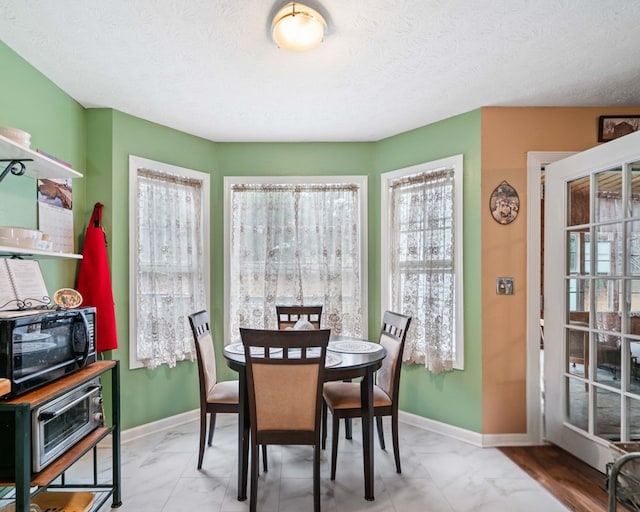 dining area with a textured ceiling