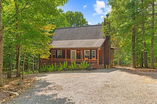 log cabin featuring covered porch