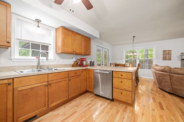 kitchen featuring light hardwood / wood-style floors, stainless steel dishwasher, ceiling fan, and kitchen peninsula