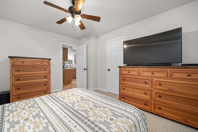 bedroom with ceiling fan and light colored carpet