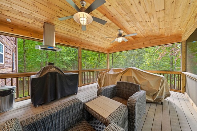 wooden terrace with ceiling fan and a grill