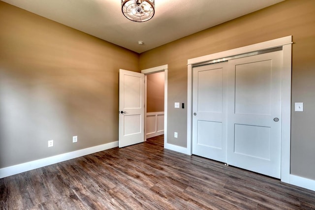 unfurnished bedroom featuring dark hardwood / wood-style flooring and a closet