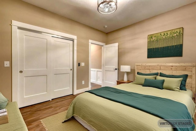 bedroom featuring wood-type flooring and a closet