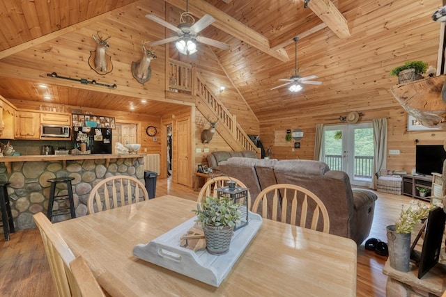 dining room featuring wooden walls and wooden ceiling