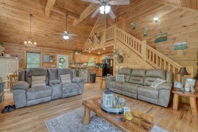 living room featuring ceiling fan with notable chandelier, light hardwood / wood-style flooring, high vaulted ceiling, wooden ceiling, and beamed ceiling